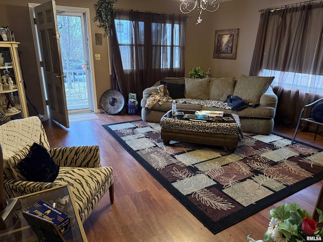 living room featuring a notable chandelier and wood-type flooring