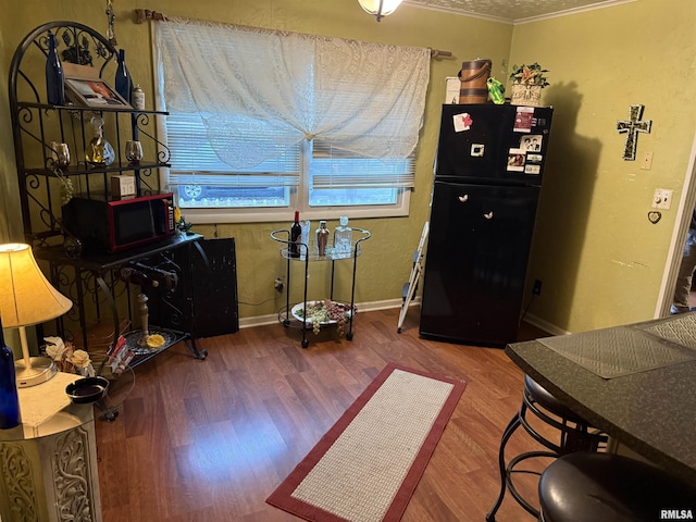 interior space with hardwood / wood-style floors and crown molding