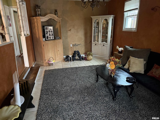 living room featuring a notable chandelier and light tile patterned floors