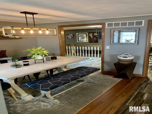 dining space featuring wood-type flooring