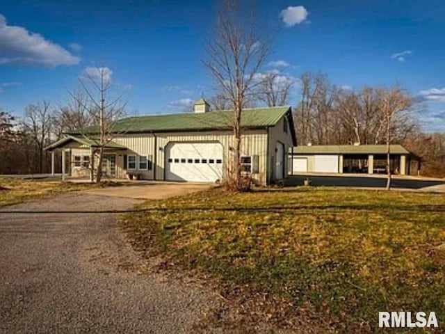 view of front of property with a garage and a front yard