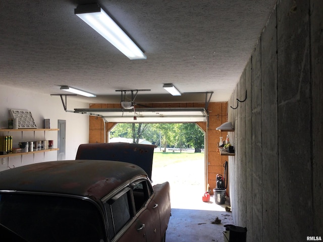 garage featuring a garage door opener and electric panel