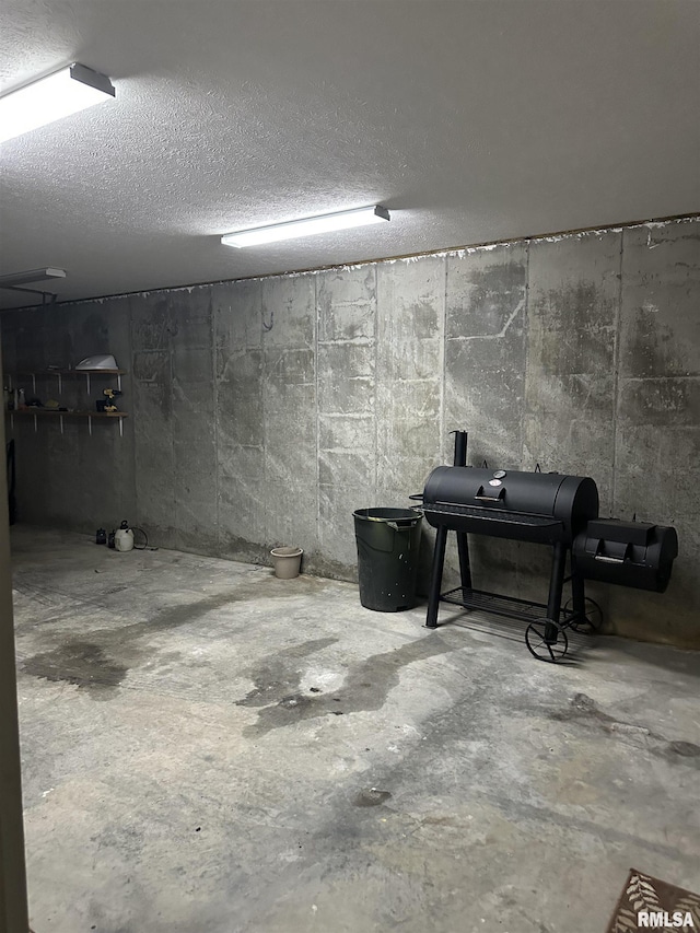 basement featuring a textured ceiling