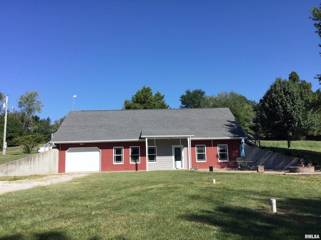 view of front of property with a garage and a front lawn