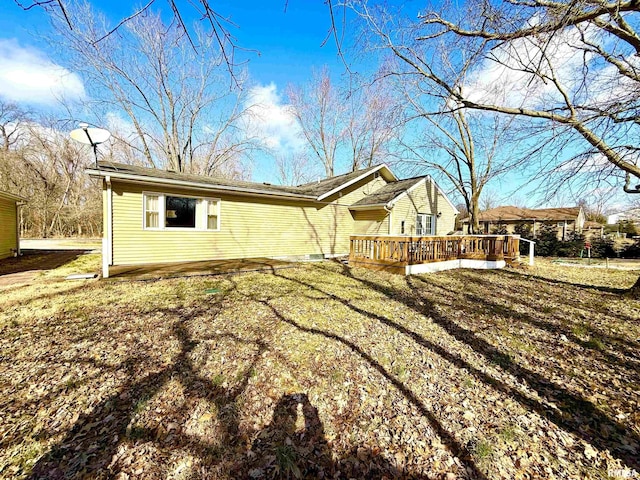 exterior space with a wooden deck and a yard