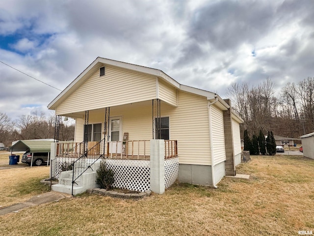 exterior space with a front lawn, a carport, and a porch