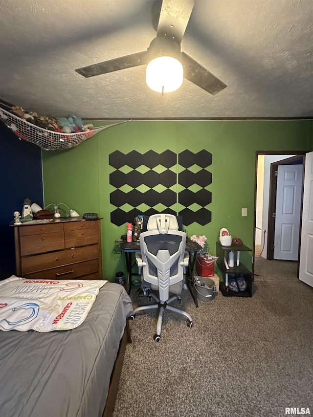 carpeted bedroom with ceiling fan and a textured ceiling