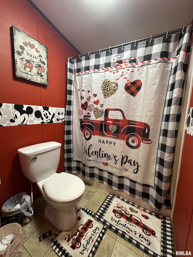 bathroom featuring toilet and a textured ceiling