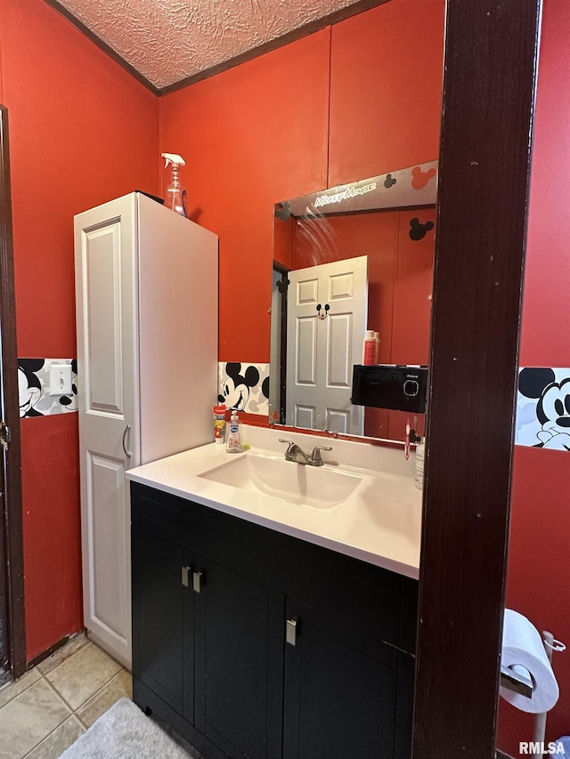 bathroom with tile patterned floors, a textured ceiling, and vanity