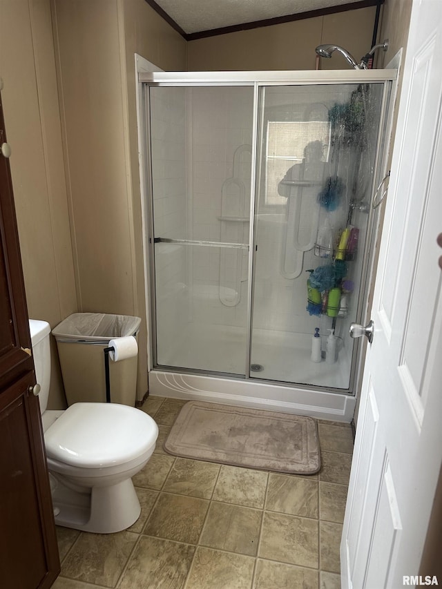 bathroom featuring an enclosed shower and toilet