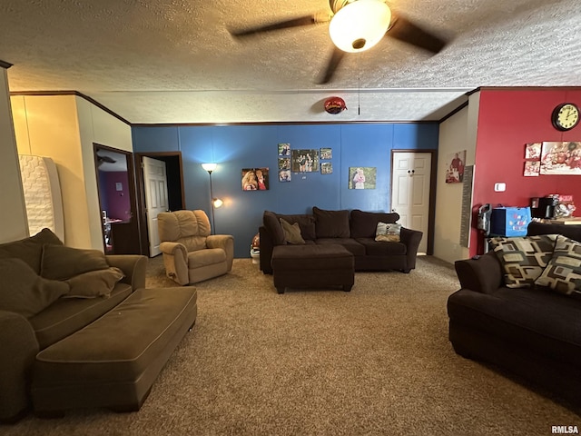 living room with ceiling fan, crown molding, a textured ceiling, and carpet flooring