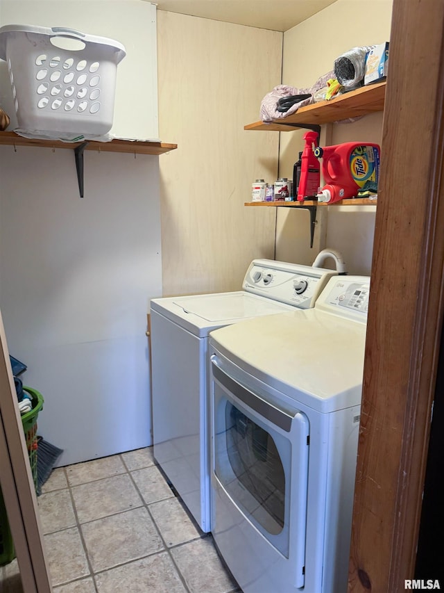 laundry area with light tile patterned flooring and independent washer and dryer