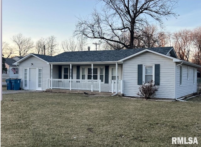 ranch-style house with a shingled roof, a porch, and a front yard