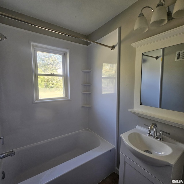 bathroom featuring shower / tub combination and vanity