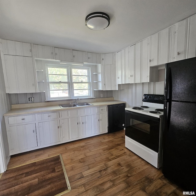 kitchen with dark wood-type flooring, sink, white cabinetry, and black appliances