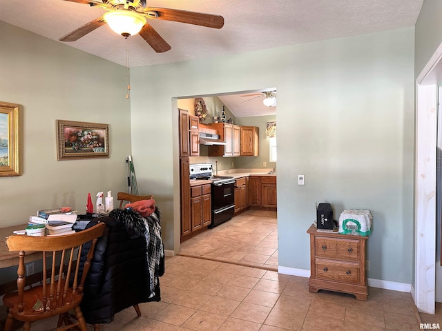 kitchen featuring light countertops, black range, lofted ceiling, under cabinet range hood, and a ceiling fan