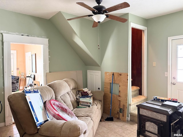 living room featuring light tile patterned floors and ceiling fan