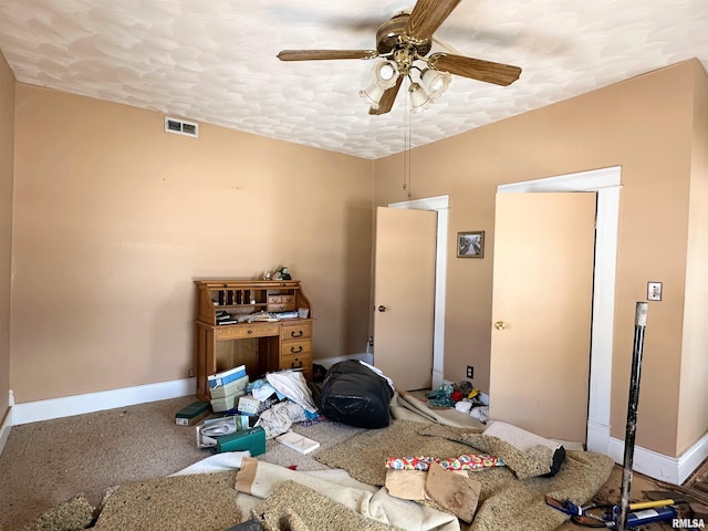 bedroom with a textured ceiling, baseboards, ceiling fan, and visible vents