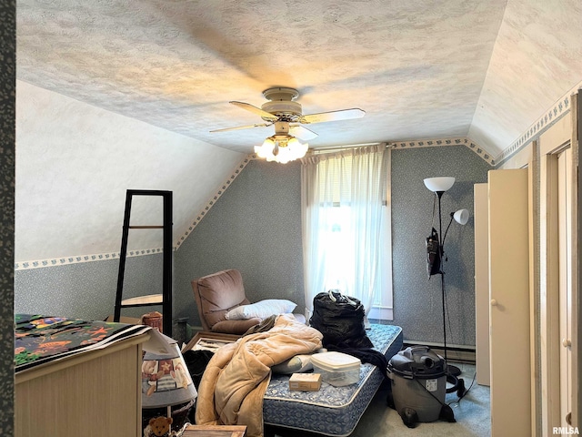bedroom with vaulted ceiling, carpet, a textured ceiling, ceiling fan, and baseboard heating