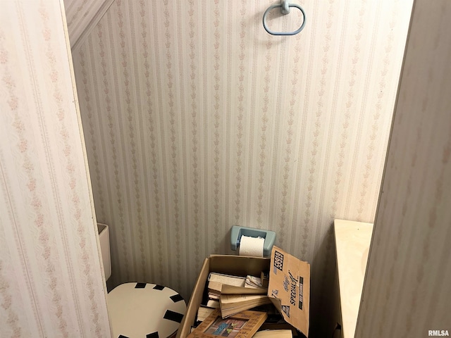 bathroom with wallpapered walls and toilet