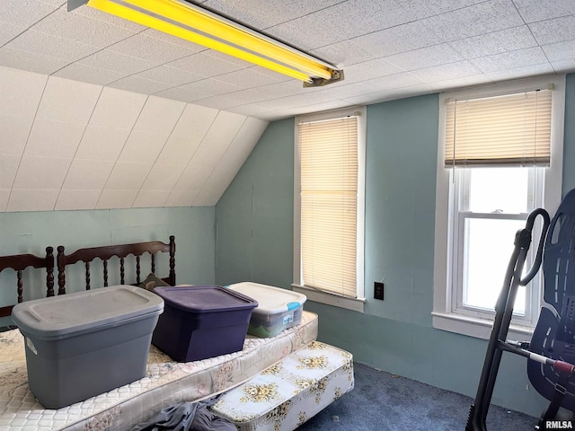 bedroom with vaulted ceiling and carpet