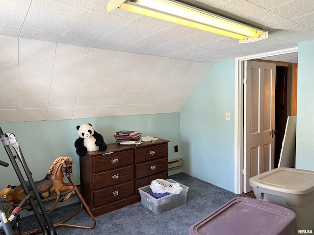 interior space with carpet flooring, lofted ceiling, and a baseboard heating unit