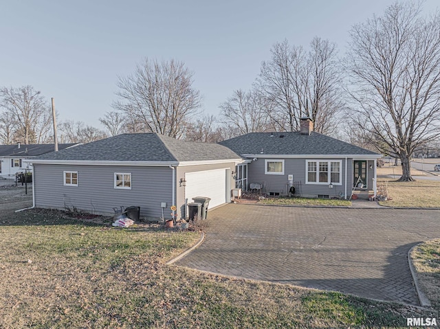 ranch-style house with a garage and a front yard