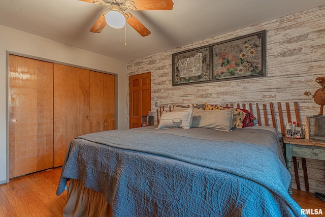 bedroom featuring hardwood / wood-style floors, a closet, and ceiling fan