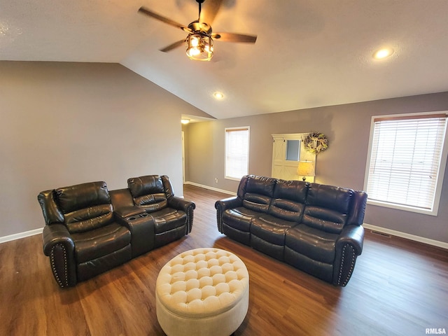 living room with ceiling fan, lofted ceiling, and dark hardwood / wood-style flooring