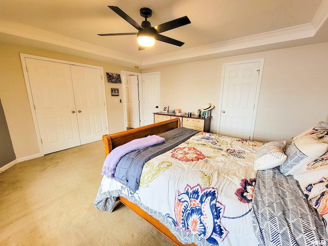 bedroom with a tray ceiling, ornamental molding, carpet flooring, and ceiling fan