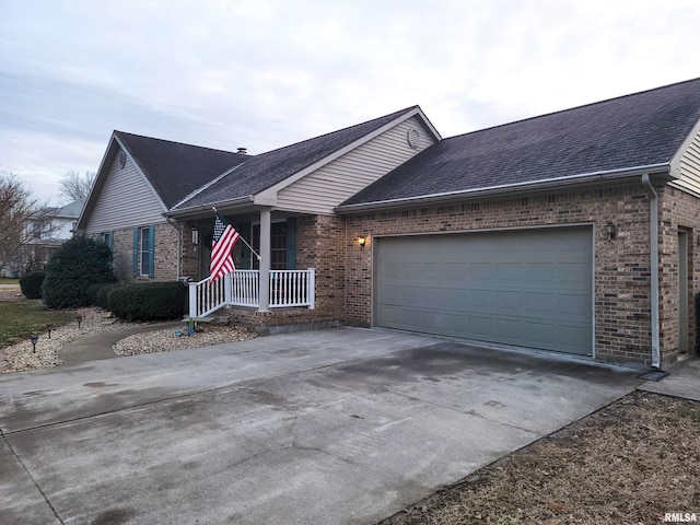 ranch-style house featuring covered porch and a garage