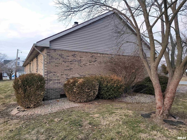 view of side of property with a yard