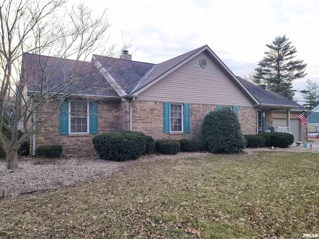 view of side of property with a yard and a garage