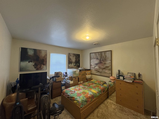 carpeted bedroom featuring a textured ceiling