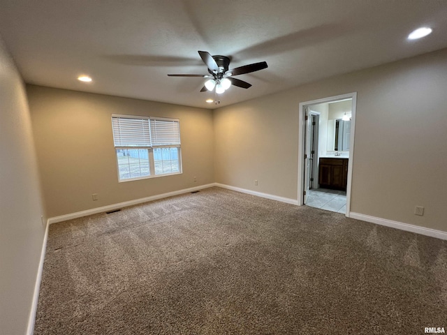 unfurnished room with recessed lighting, light carpet, visible vents, a ceiling fan, and baseboards