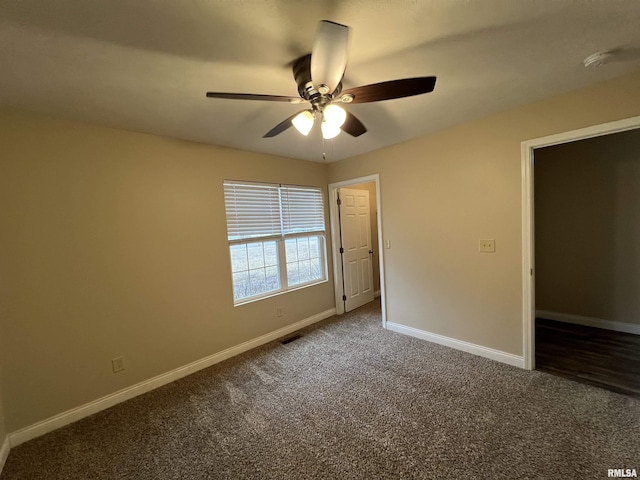 unfurnished bedroom with carpet floors, visible vents, baseboards, and a ceiling fan