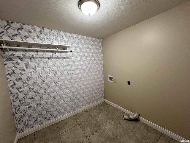 washroom featuring washer hookup, hookup for an electric dryer, a textured ceiling, laundry area, and baseboards