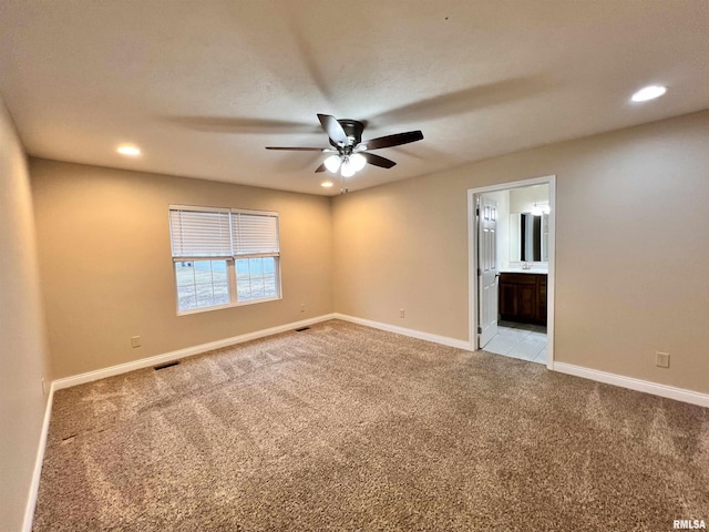 spare room featuring light carpet, baseboards, a ceiling fan, and recessed lighting