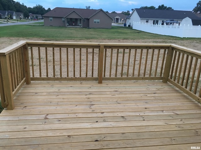 deck with a residential view and a yard