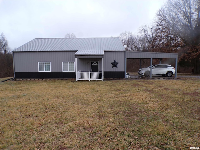 view of outbuilding featuring a yard, a carport, and a porch