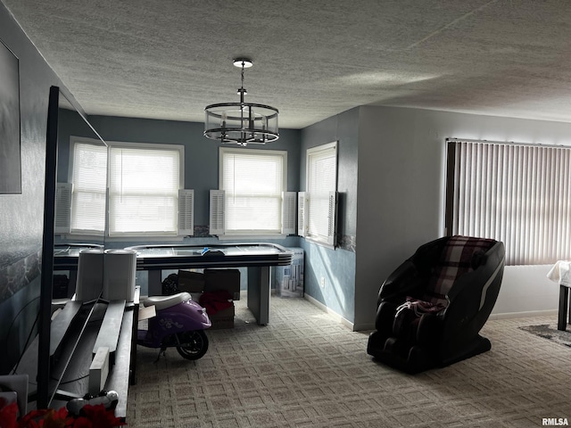 interior space featuring a notable chandelier, light carpet, and a textured ceiling