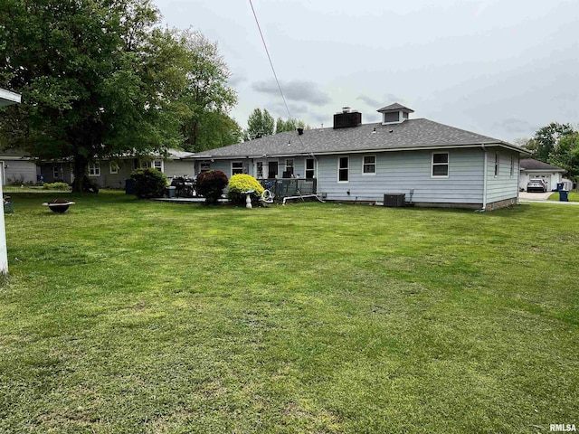 5 Evergreen Dr, Mount Vernon, IL 62864 - rear view of house featuring a lawn, a chimney, and central AC unit