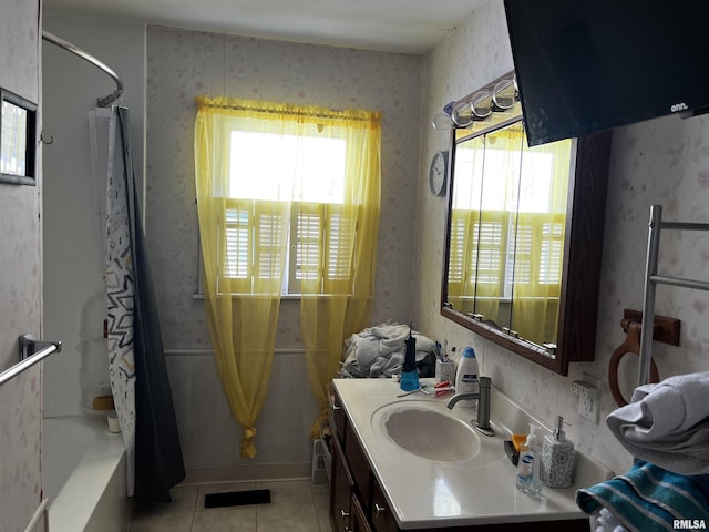 bathroom with tile patterned floors, vanity, and shower / bathtub combination with curtain