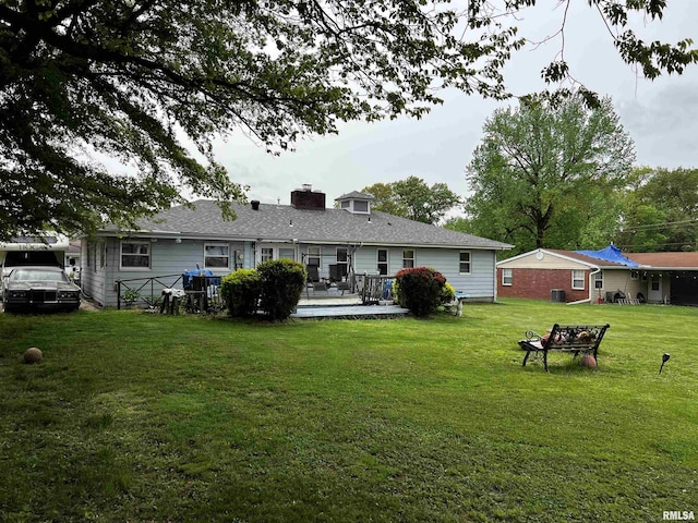 5 Evergreen Dr, Mount Vernon, IL 62864 - rear view of house featuring a yard, a wooden deck, a chimney, and central air condition unit