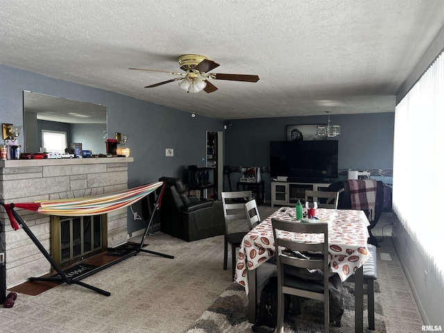 carpeted dining area featuring ceiling fan and a textured ceiling