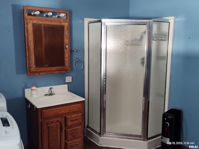 bathroom with an enclosed shower and vanity