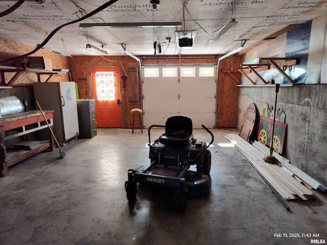 garage with refrigerator and a garage door opener