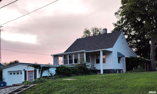 514 W Randolph St, Mcleansboro, IL 62859 - view of front of property featuring a lawn, a shingled roof, a chimney, and an attached garage