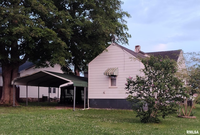 514 W Randolph St, Mcleansboro, IL 62859 - back of house with a carport, a lawn, and a chimney