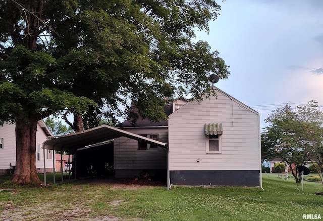 514 W Randolph St, Mcleansboro, IL 62859 - view of home's exterior featuring a lawn and a carport